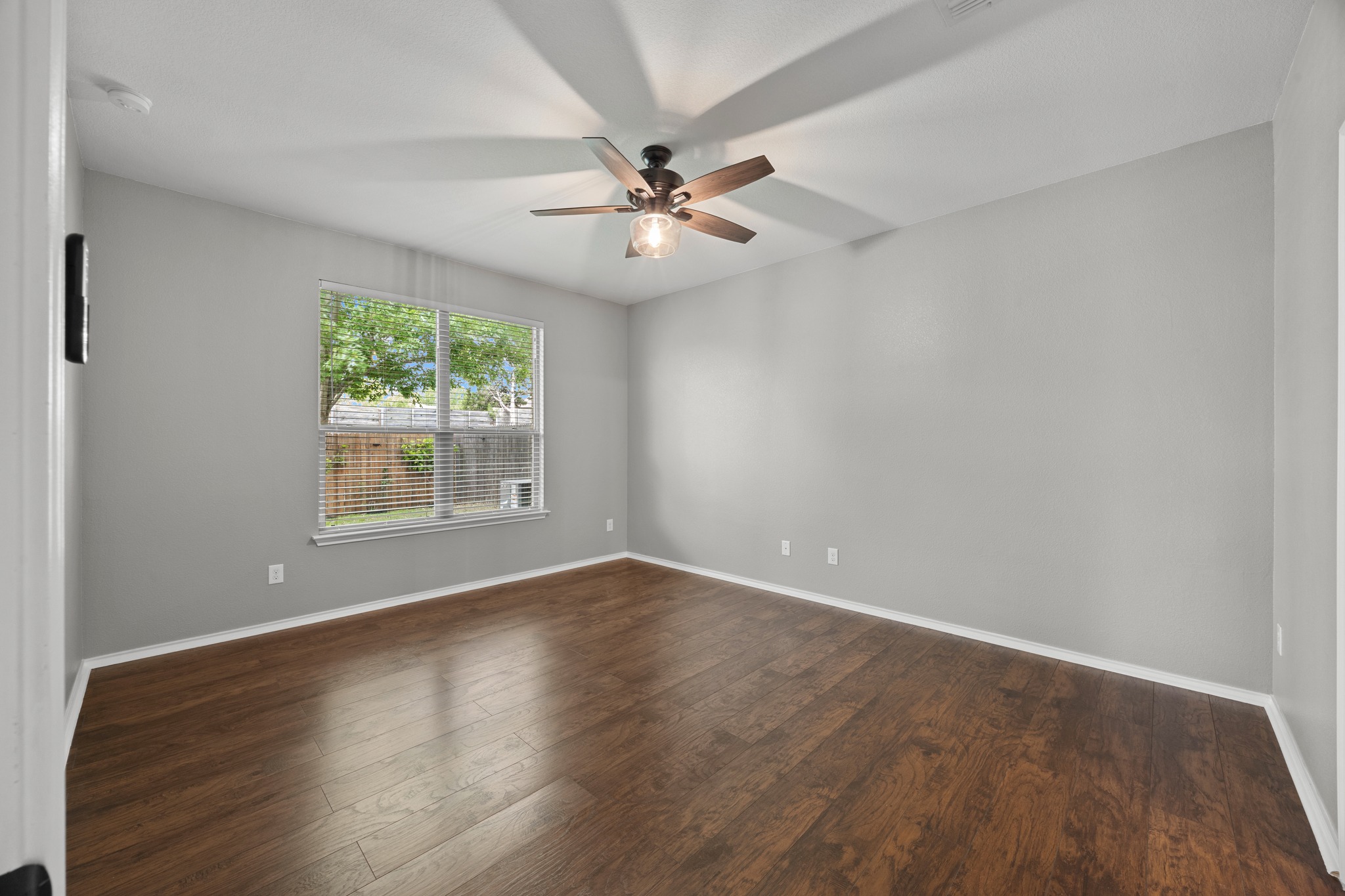 1125 Yellow Iris Road Leander, TX 78641 - Photo 22 of 31 Unfurnished bedroom with dark wood finished floors and ceiling fan
