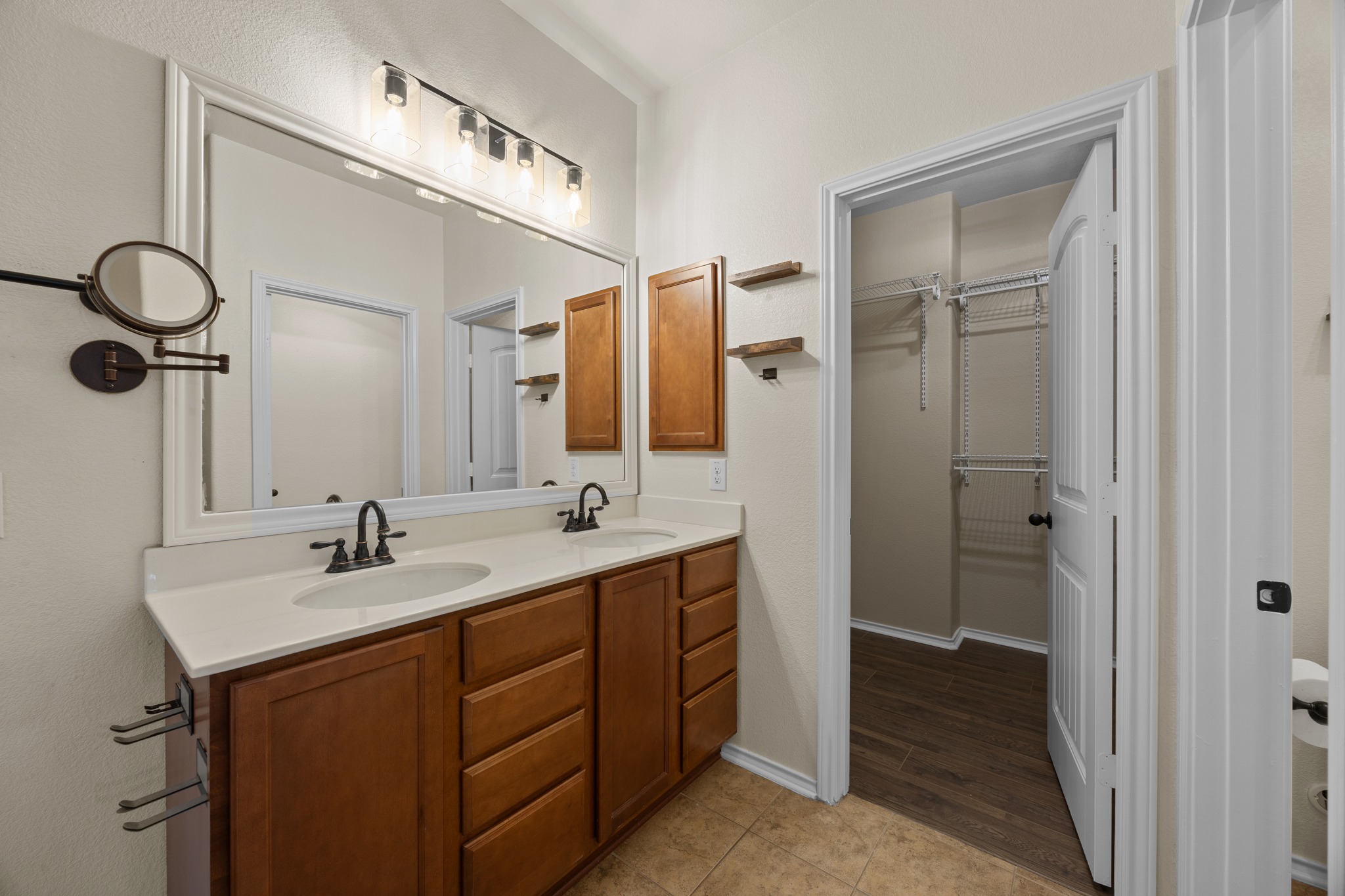 1125 Yellow Iris Road Leander, TX 78641 - Photo 25 of 31 Full bathroom with double vanity, light tile patterned floors, and a walk in closet