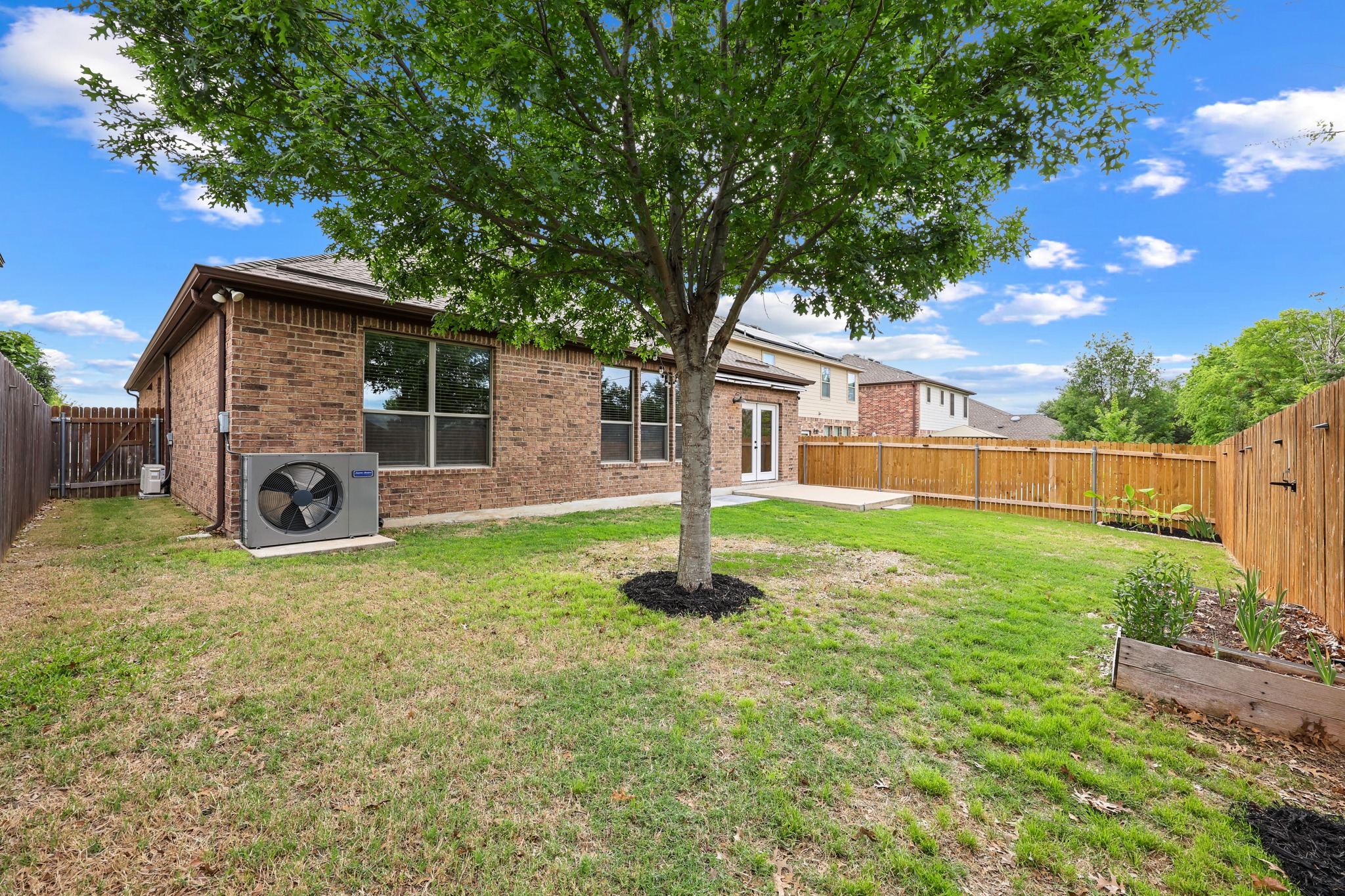 1125 Yellow Iris Road Leander, TX 78641 - Photo 29 of 31 Back of house with brick siding, a patio, and a fenced backyard