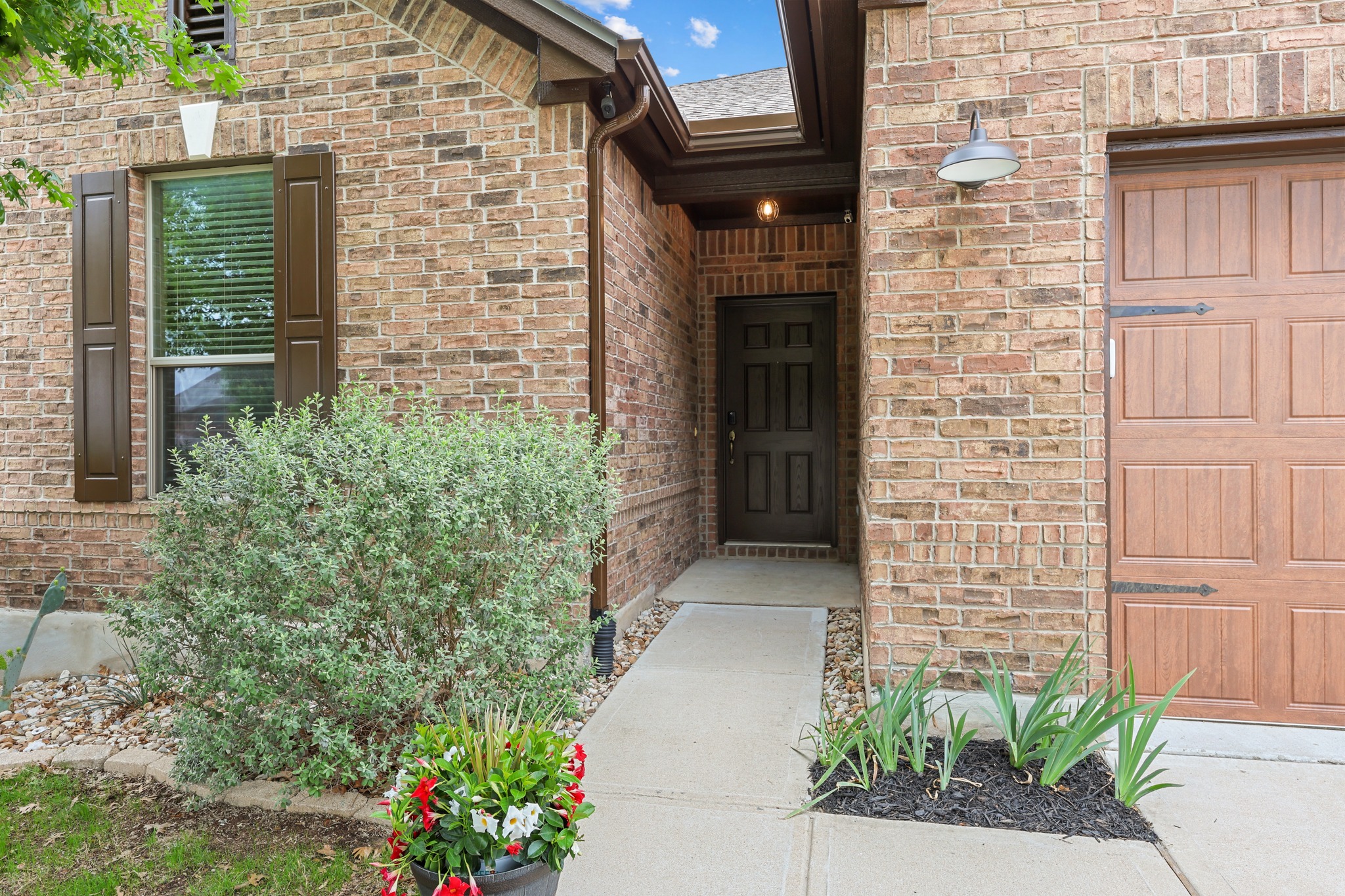 1125 Yellow Iris Road Leander, TX 78641 - Photo 3 of 31 Property entrance featuring brick siding and a garage