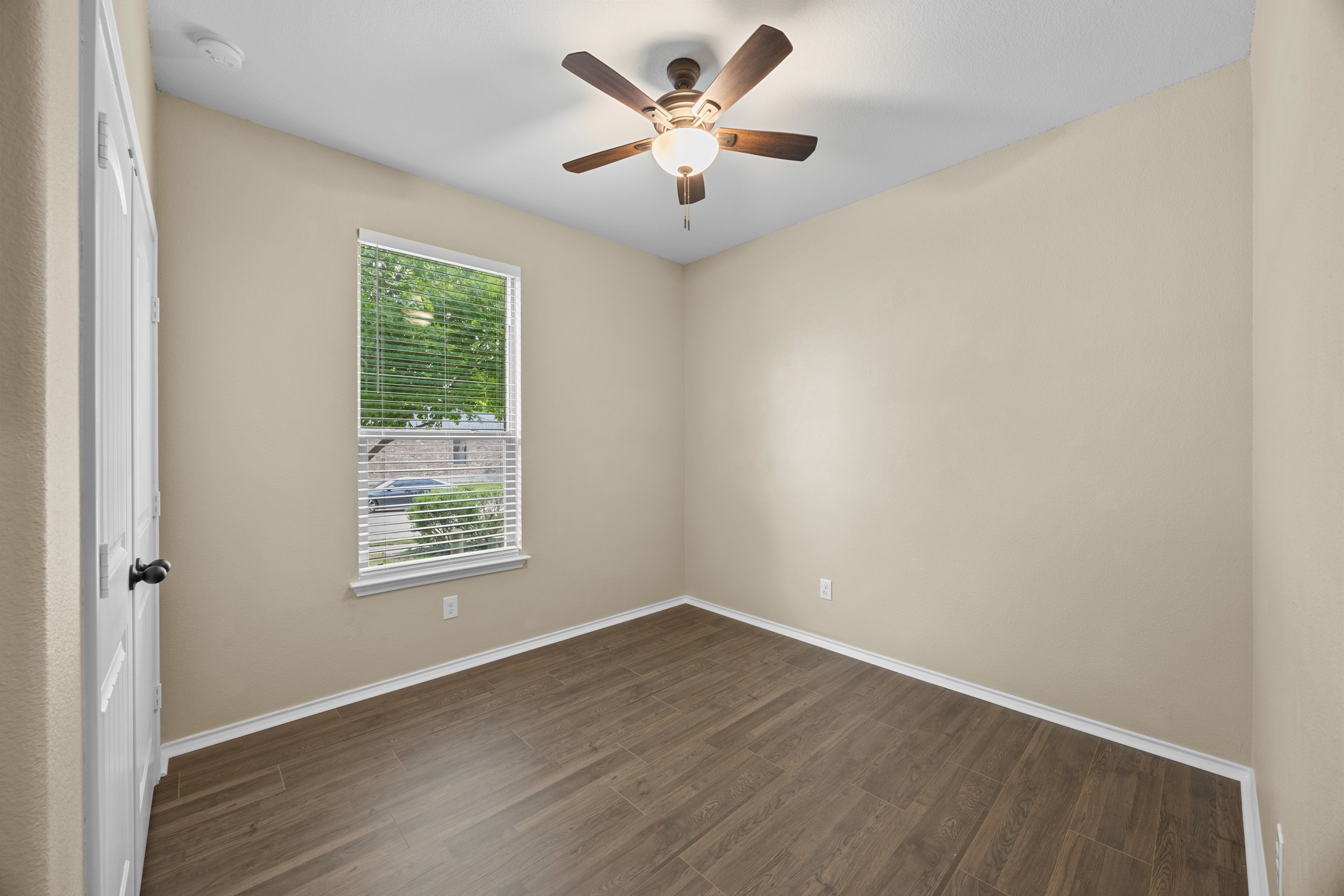 1125 Yellow Iris Road Leander, TX 78641 - Photo 5 of 31 Unfurnished bedroom with dark wood finished floors, a ceiling fan, and a smoke detector