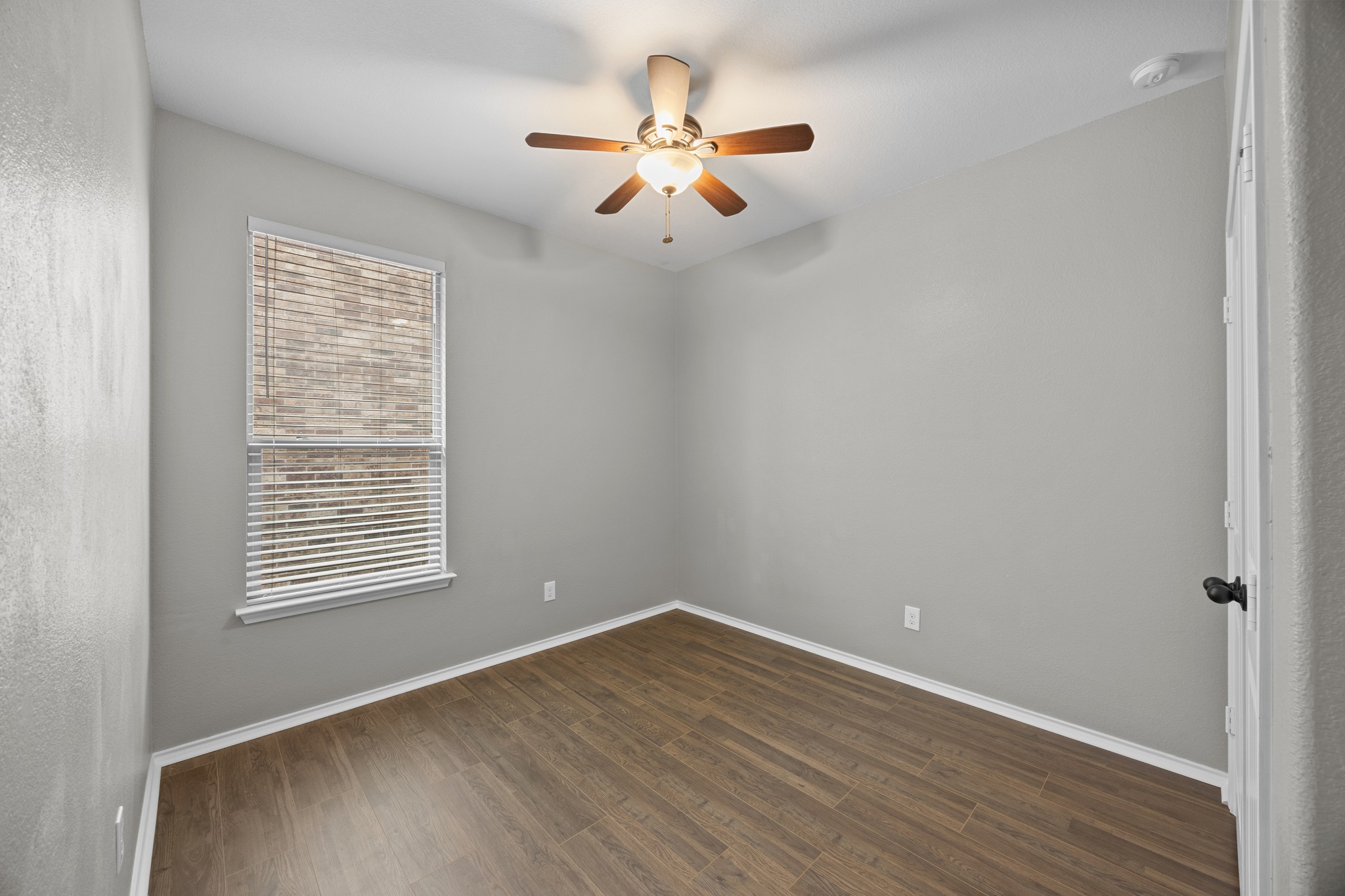 1125 Yellow Iris Road Leander, TX 78641 - Photo 7 of 31 Unfurnished bedroom with dark wood-style floors and a ceiling fan