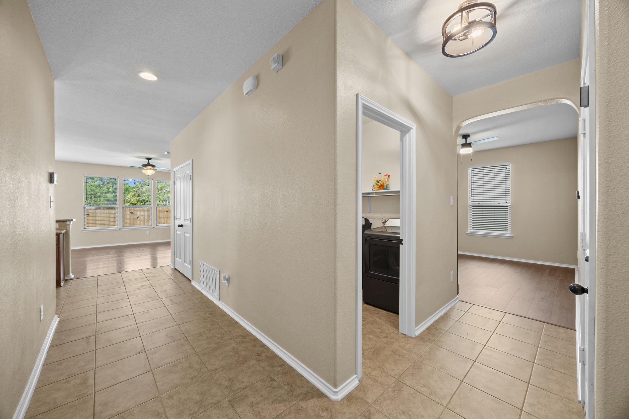 1125 Yellow Iris Road Leander, TX 78641 - Photo 10 of 31 Hall with light tile patterned floors and arched walkways