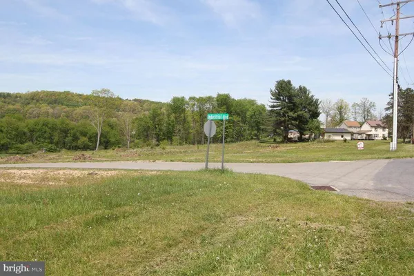 a view of a field with an ocean beach