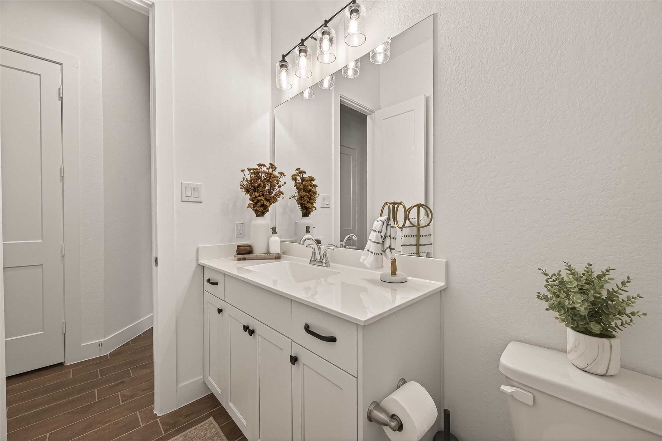 5019 Country Mdws Trail Rosharon, TX 77583 - Photo 27 of 49 a bathroom with a sink a toilet and mirror