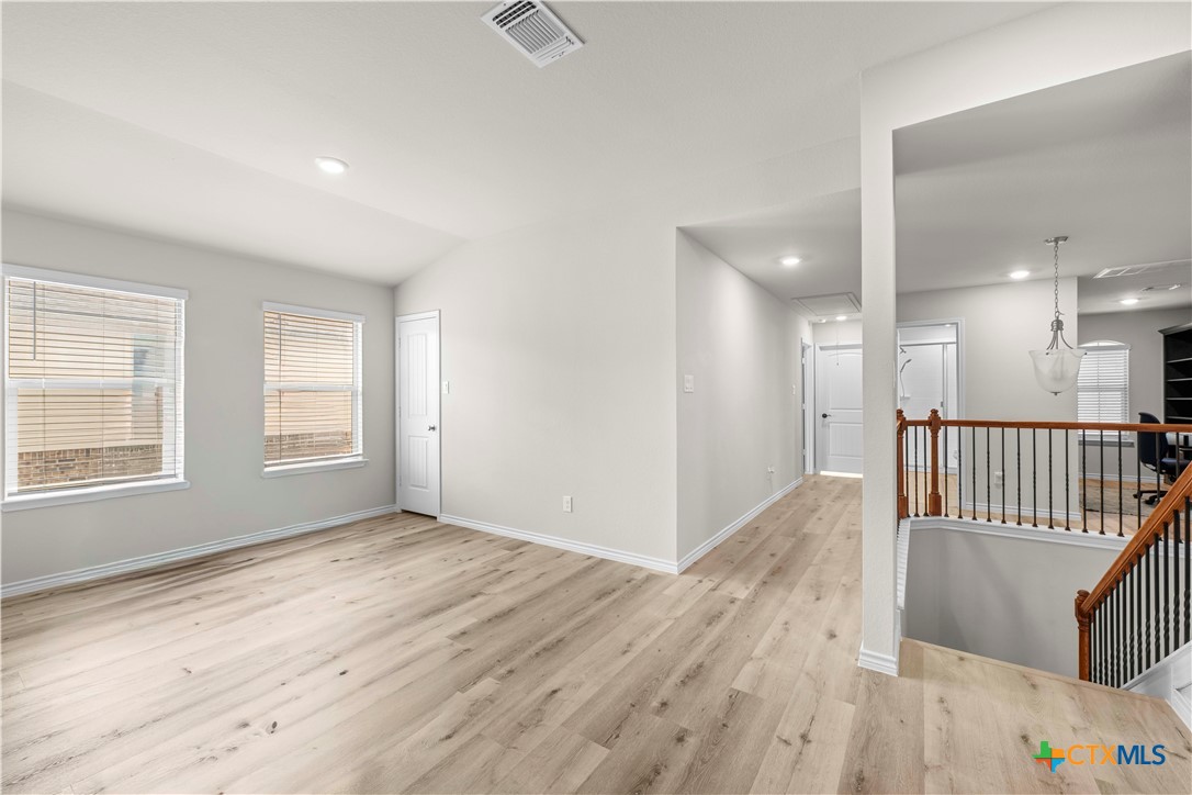 1305 Roma Street Harker Heights, TX 76548 - Photo 12 of 28 an empty room with wooden floor and windows
