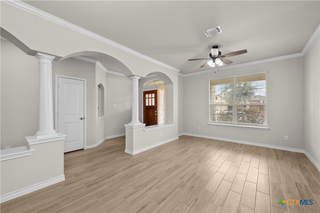 1305 Roma Street Harker Heights, TX 76548 - Photo 3 of 28 a view of an empty room with a window and wooden floor
