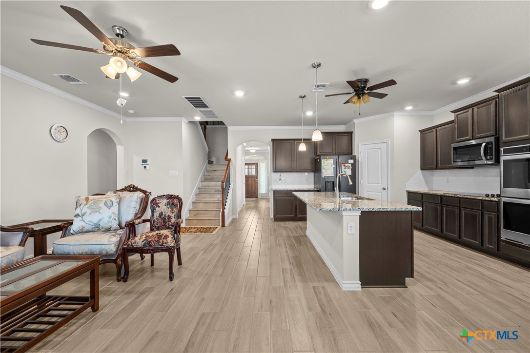 1305 Roma Street Harker Heights, TX 76548 - Photo 7 of 28 a living room with furniture kitchen view and a wooden floor