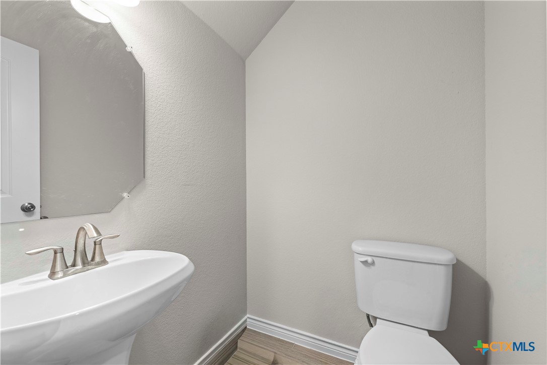 1305 Roma Street Harker Heights, TX 76548 - Photo 8 of 28 a white toilet sitting next to a bathroom sink