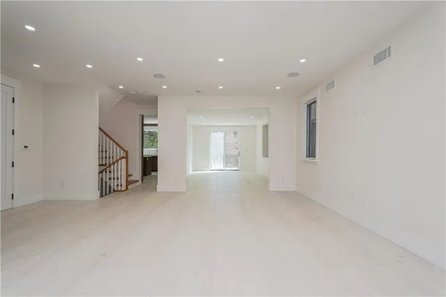 a view of an empty room with stairs