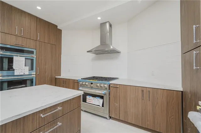 a kitchen with stainless steel appliances a stove and a refrigerator