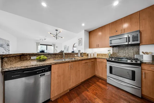 a kitchen with a refrigerator and a stove