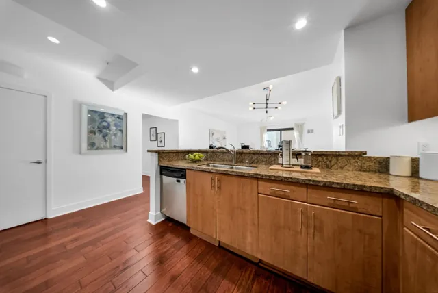 a living room with furniture a window and a chandelier
