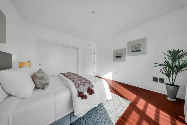 a view of a hallway with wooden floor and a sink