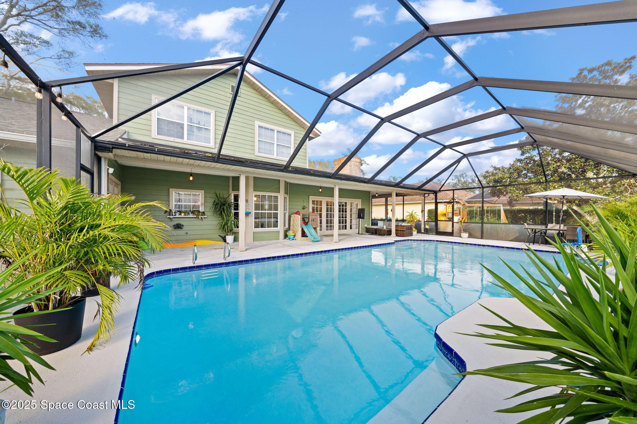 3705 Eagle Way Melbourne, FL 32934 - Photo 2 of 47 a view of a swimming pool with a patio