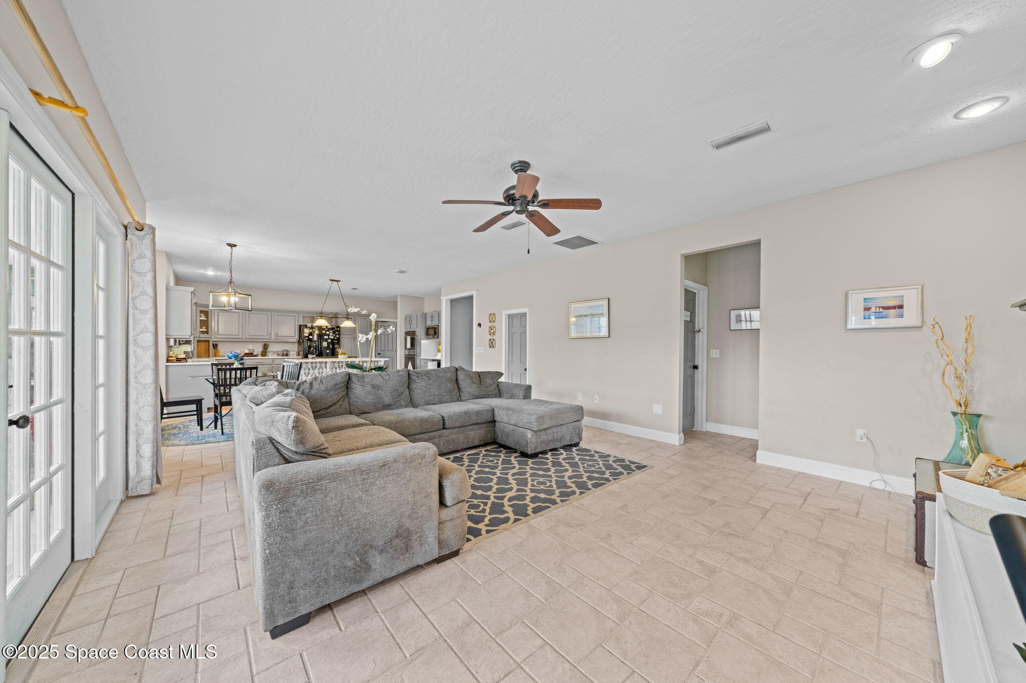3705 Eagle Way Melbourne, FL 32934 - Photo 23 of 47 a living room with furniture and a ceiling fan