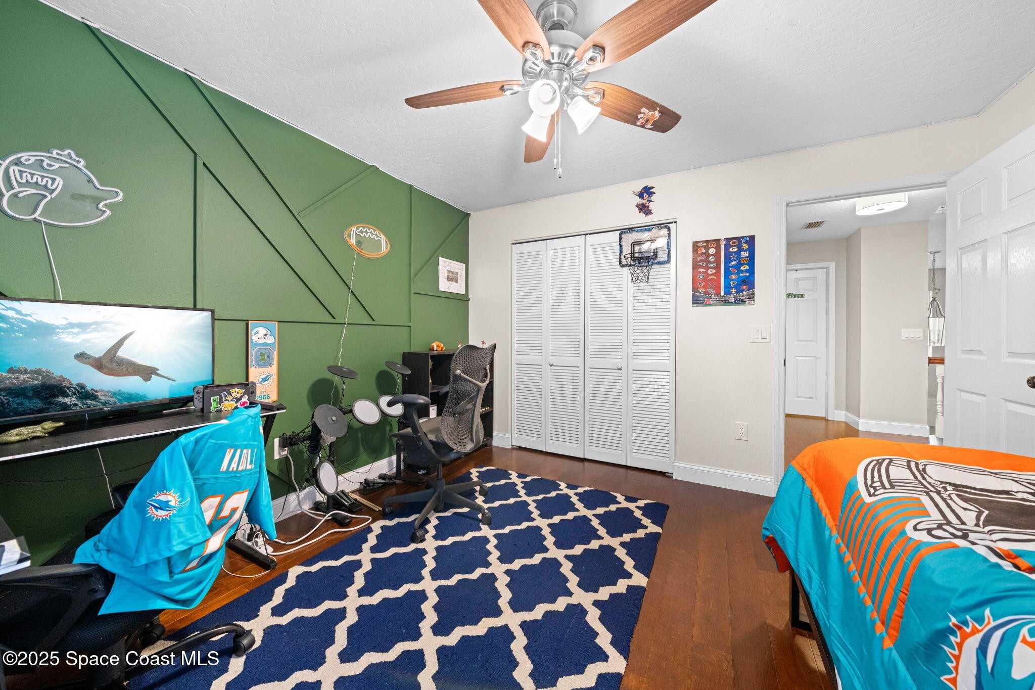 3705 Eagle Way Melbourne, FL 32934 - Photo 38 of 47 a bedroom with a bed and a chandelier