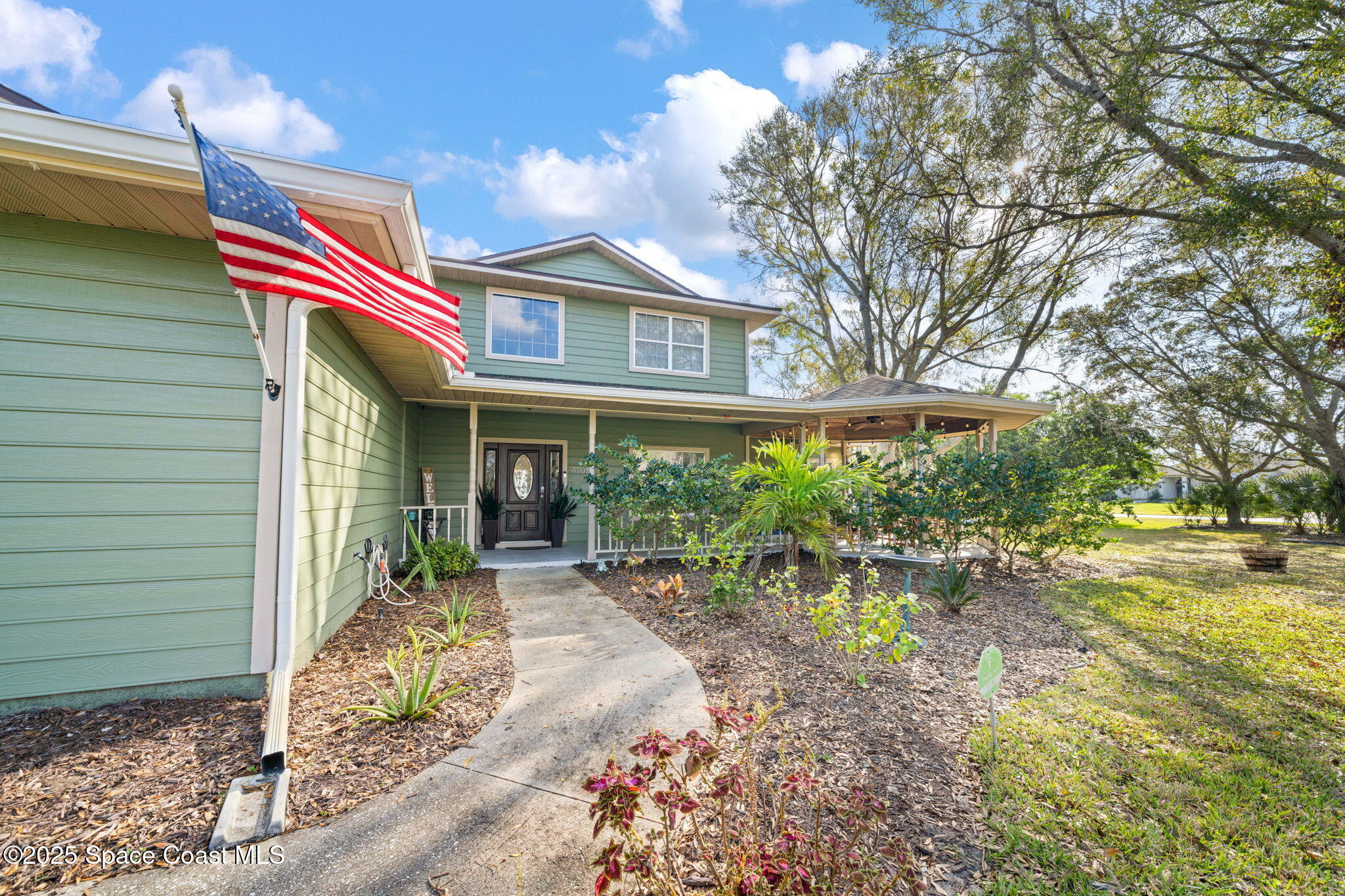 3705 Eagle Way Melbourne, FL 32934 - Photo 5 of 47 a front view of a house with garden