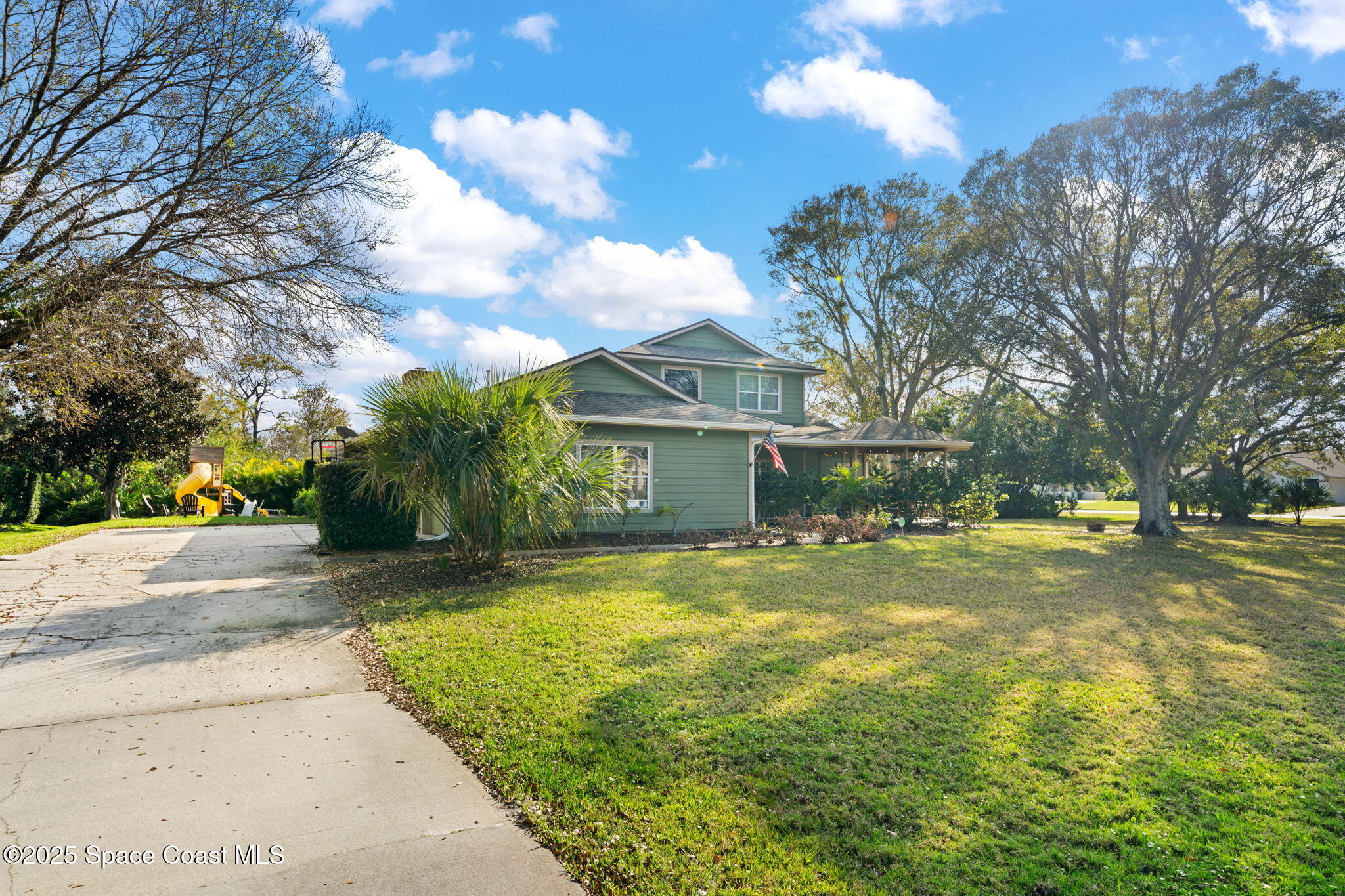 3705 Eagle Way Melbourne, FL 32934 - Photo 6 of 47 a view of a house with a yard and garage