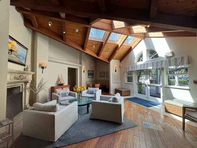 a living room with fireplace furniture and a large window