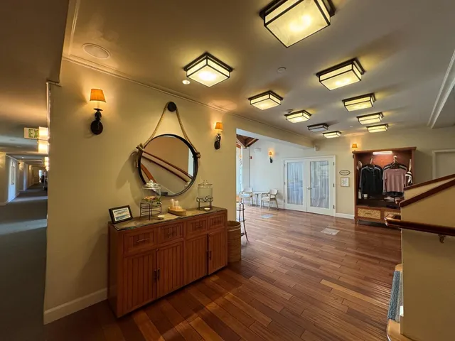 a living room with wooden floor and gym equipment
