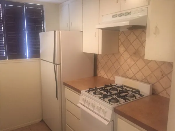 a kitchen with a stove and a refrigerator