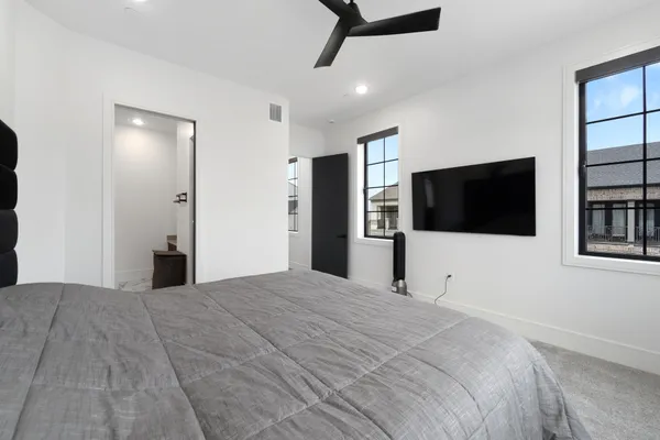 a bedroom with a bed and a window