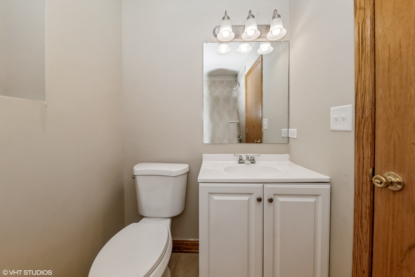 5316 South Kenneth Avenue, Unit 101 Chicago, IL 60632 - Photo 5 of 15 a bathroom with a toilet sink and mirror