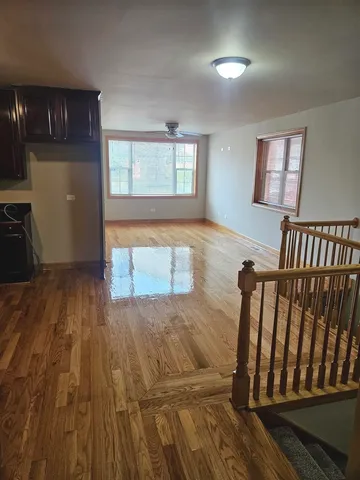 a view of an empty room and wooden floor