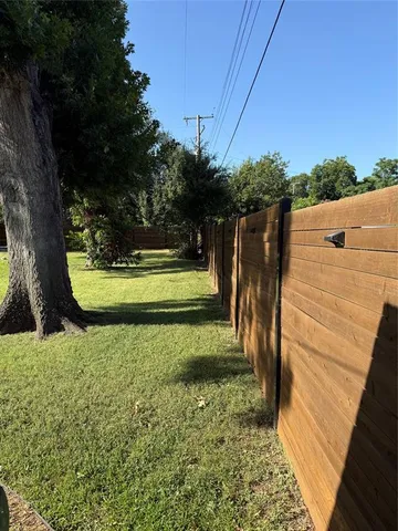 a view of a house with a yard and sitting area