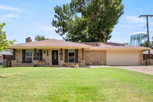 a view of a house with a yard and sitting area
