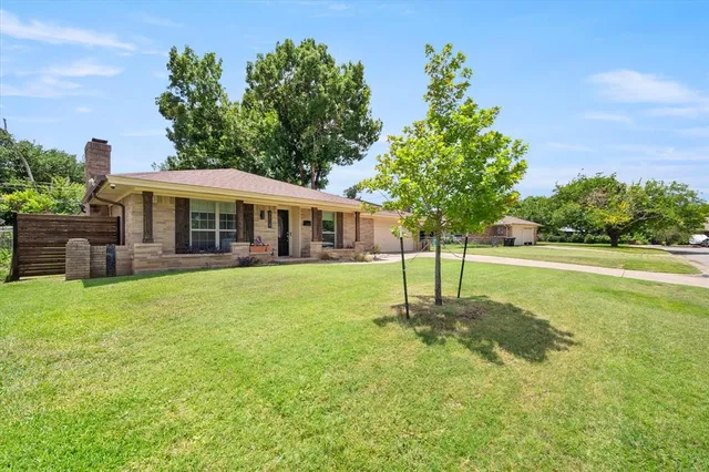 a view of a house with a yard and sitting area