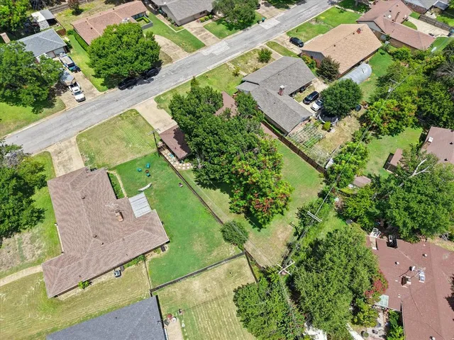 an aerial view of residential houses with outdoor space and street view