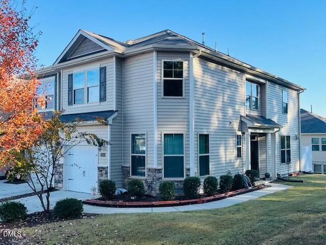 a front view of a house with a yard