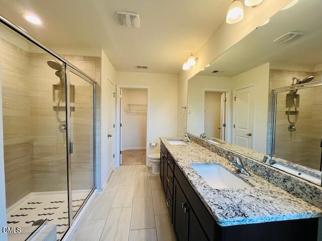 1423 Compass Drive Durham, NC 27713 - Photo 17 of 19 a bathroom with a granite countertop sink a mirror and a shower