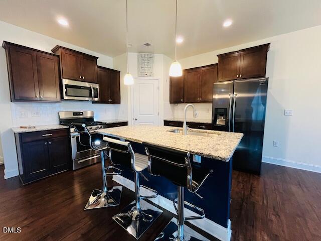 1423 Compass Drive Durham, NC 27713 - Photo 5 of 19 a kitchen with stainless steel appliances a table chairs refrigerator and microwave