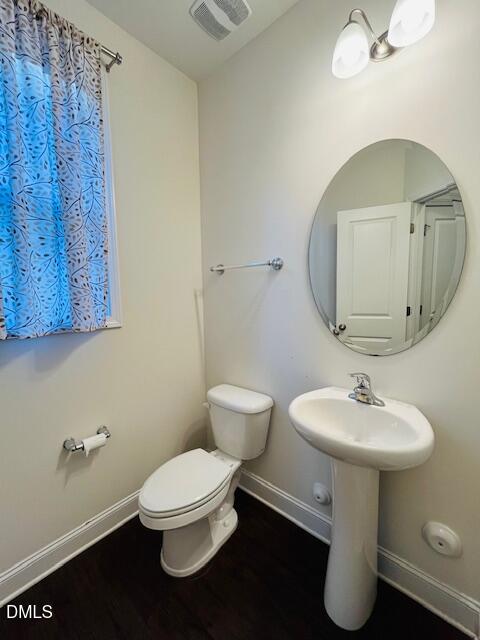 1423 Compass Drive Durham, NC 27713 - Photo 7 of 19 a bathroom with a toilet sink and mirror