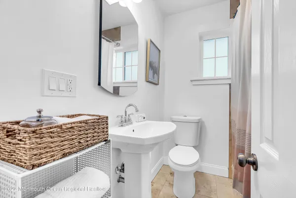 a bathroom with a granite countertop toilet sink and mirror
