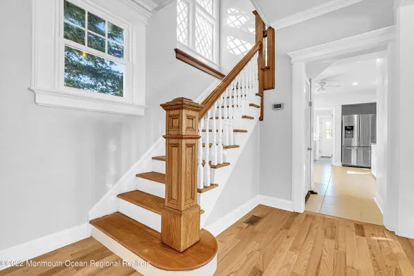 a view of entryway with wooden floor and stairs