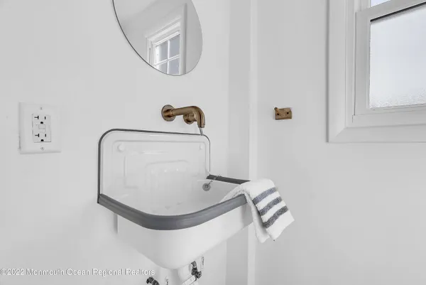 a bathroom with a mirror and a sink