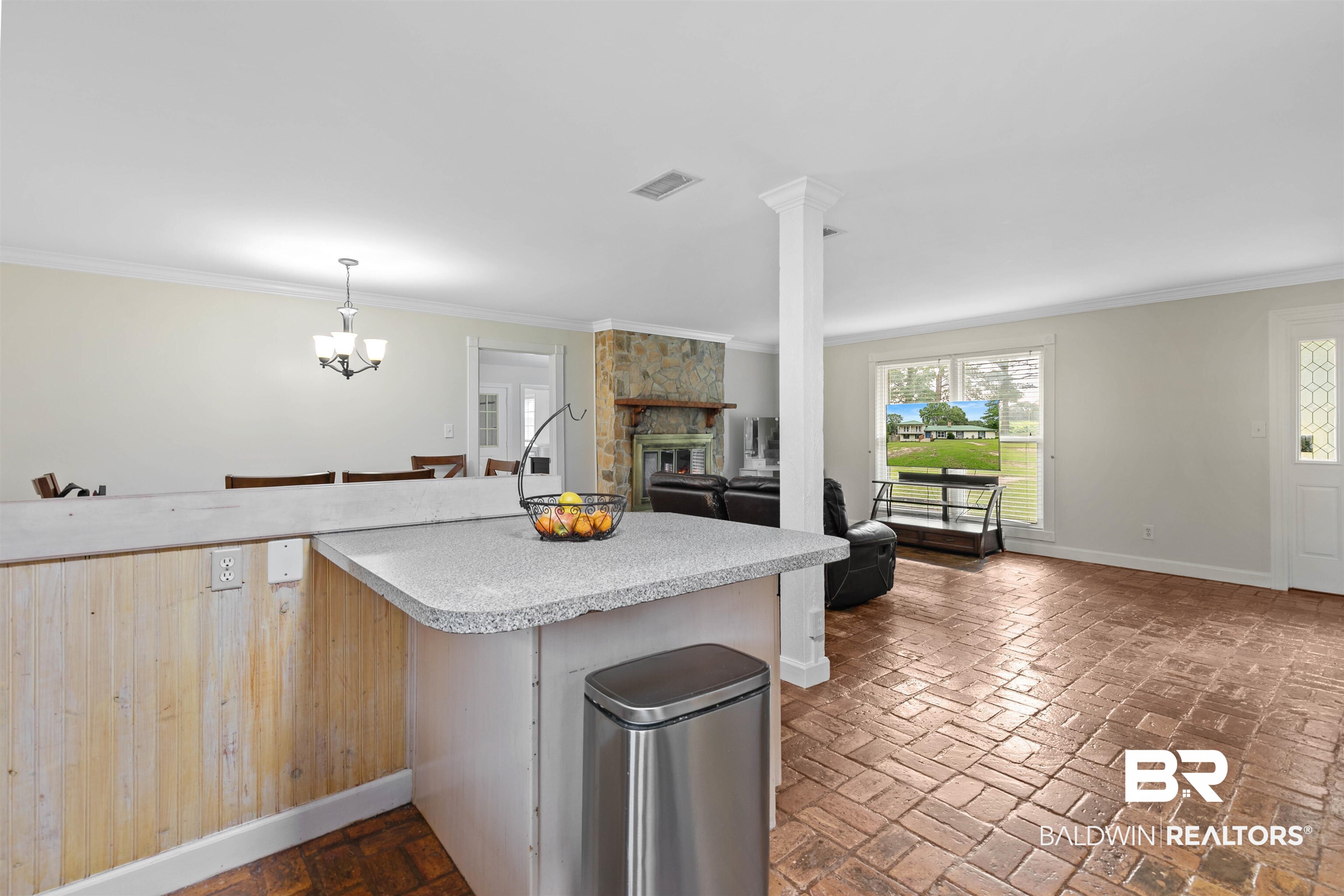 10420 Johnson Road South Mobile, AL 36695 - Photo 25 of 75 Open-concept living area featuring brick-pattern flooring and a stone fireplace