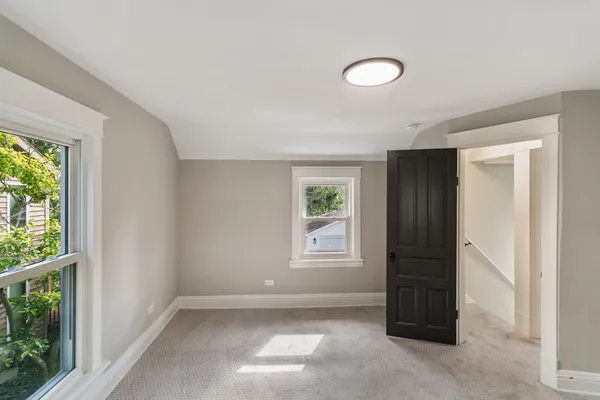 an empty room with windows and closet