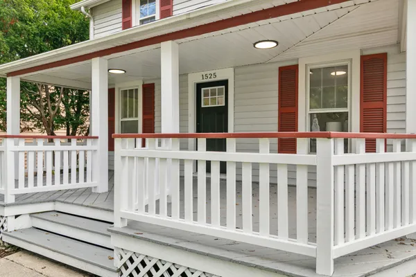 a view of a brick house with large windows