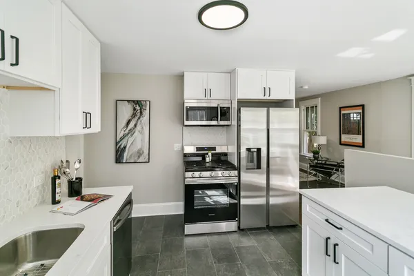 a kitchen with stainless steel appliances a refrigerator sink and stove