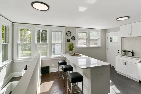 a large kitchen with a table and chairs in it