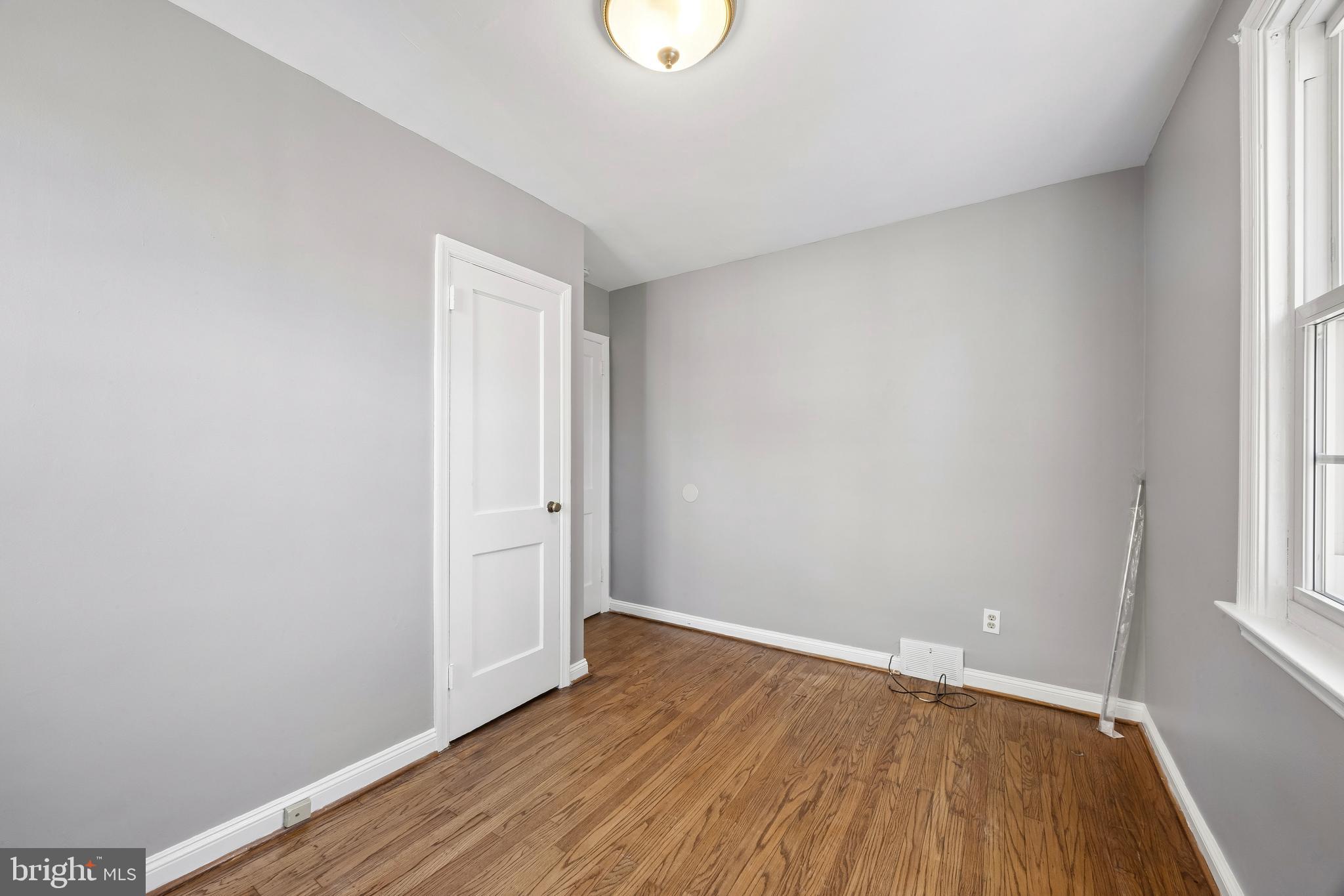 336 Valley View Road Springfield, PA 19064 - Photo 12 of 24 a view of an empty room with wooden floor and a window
