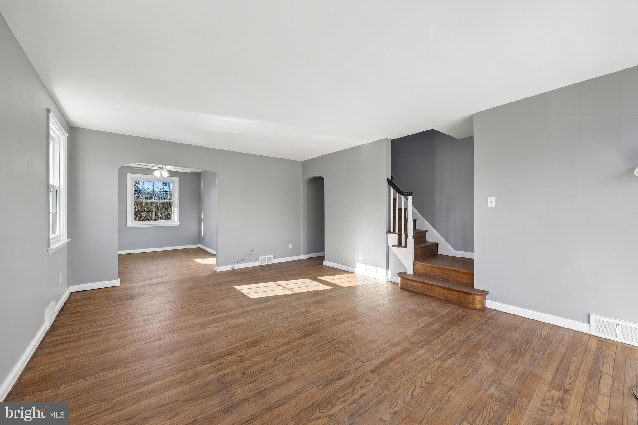 336 Valley View Road Springfield, PA 19064 - Photo 2 of 24 an empty room with wooden floor and windows