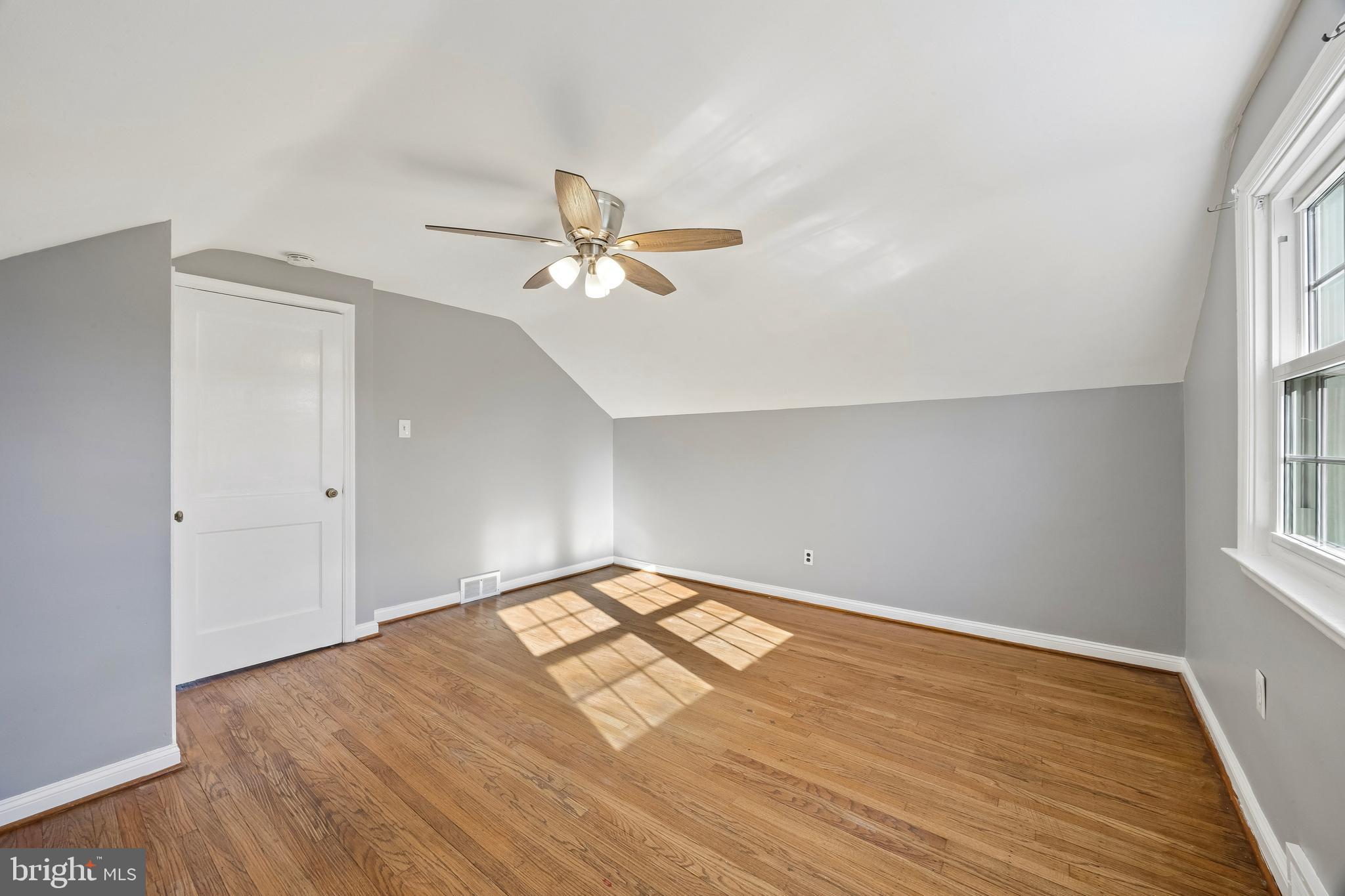 336 Valley View Road Springfield, PA 19064 - Photo 21 of 24 an empty room with wooden floor and windows