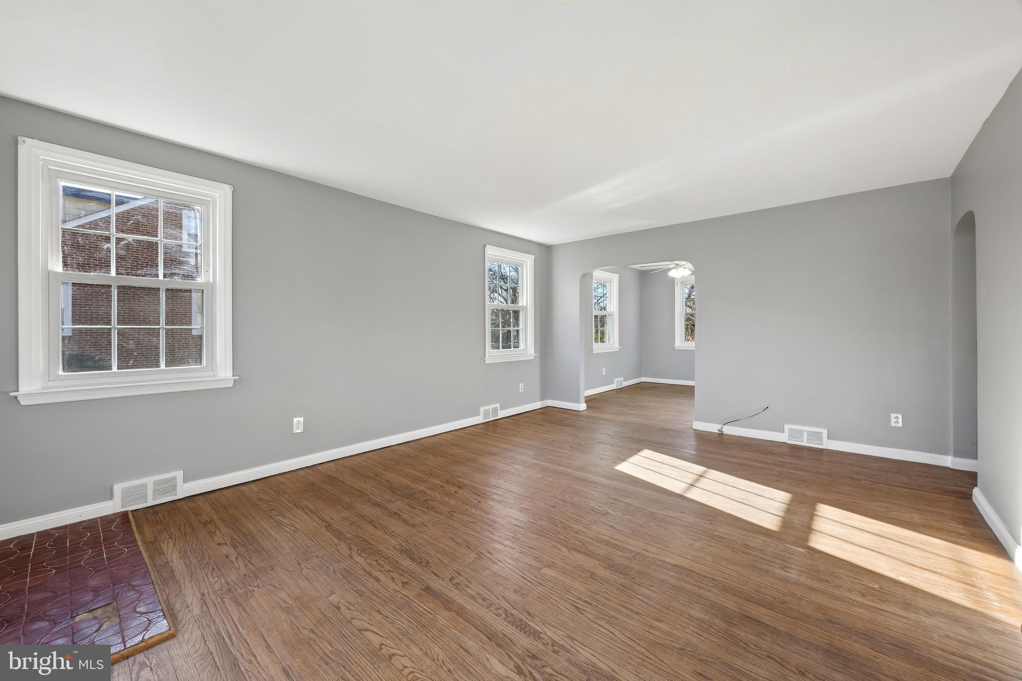 336 Valley View Road Springfield, PA 19064 - Photo 3 of 24 a view of empty room with wooden floor and fan