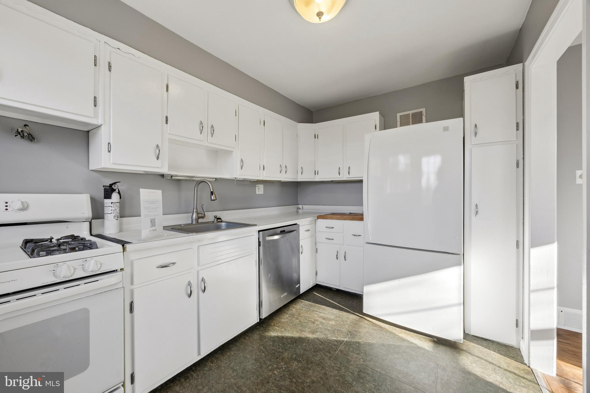 336 Valley View Road Springfield, PA 19064 - Photo 8 of 24 a kitchen with stainless steel appliances white cabinets and a refrigerator